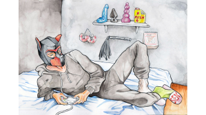 Man in a onesie and a fetish mask, lying on a bed with sex toys in the background.