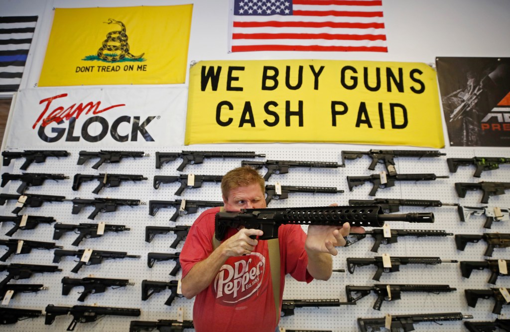 A worker inspects an AR-15 gun at Davidson Defense in Orem, Utah on March 20, 2020