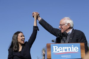 Democratic presidential candidate, Sen. Bernie Sanders (I-VT) holds hands with Rep. Alexandria Ocasio-Cortez (D-NY) during his speech at a campaign rally in Queensbridge Park on October 19, 2019 in the Queens borough of New York City.