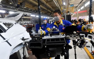 Workers work on the assembly line at a factory of vehicle manufacturer BYD Auto in Xi'an, northwest China's Shaanxi Province, Feb. 25, 2020.