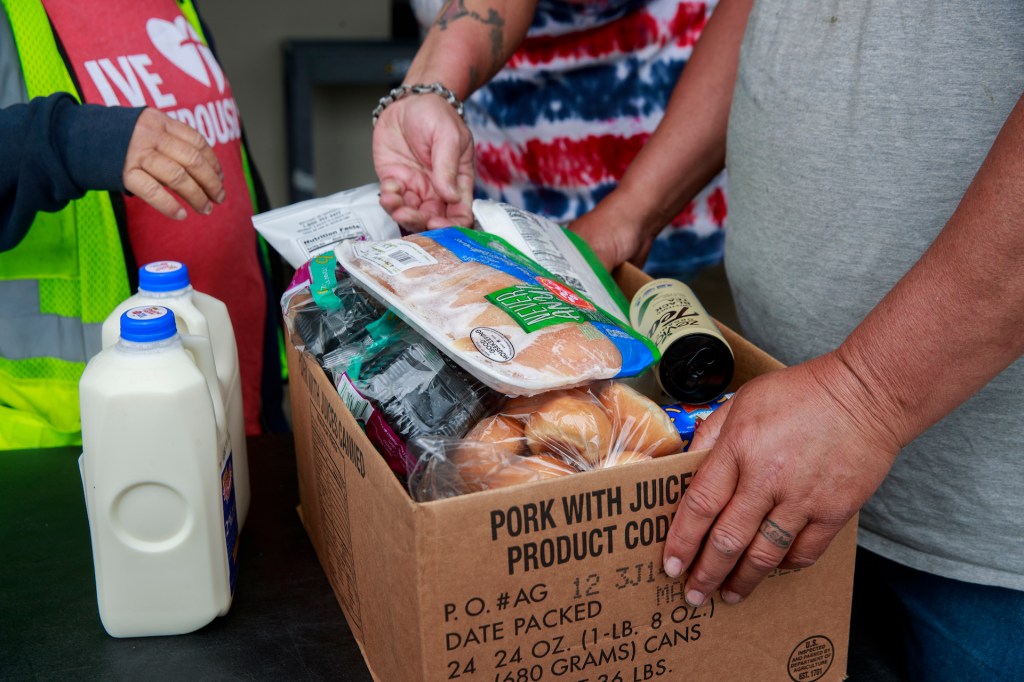 Volunteers at Pantry 279 distribute food to area residents experiencing food insecurity during the COVID-19 Coronavirus emergency. (Photo by Jeremy Hogan / SOPA Images/Sipa USA)(Sipa via AP Images)​