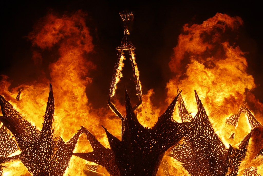 The Man burns at Burning Man 2009; image shows fire and smoke around its skeletal structure