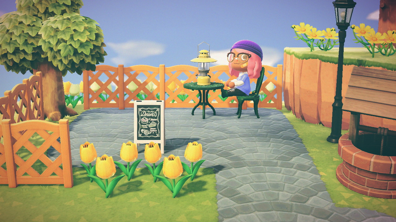 An Animal Crossing villager sitting on a bench outside.