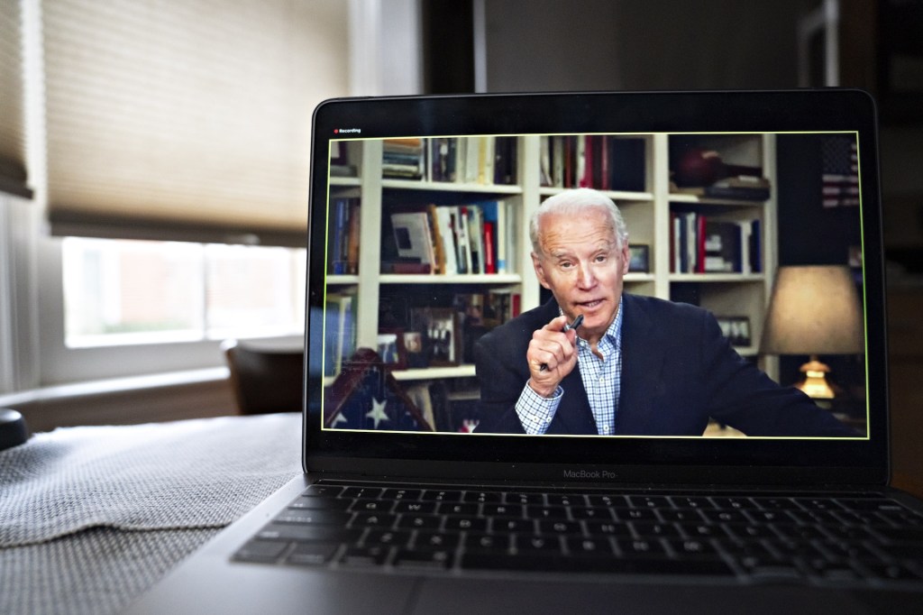 Former Vice President Joe Biden, 2020 Democratic presidential candidate, speaks during a virtual press briefing on a laptop computer in this arranged photograph in Arlington, Virginia, U.S., on Wednesday, March 25, 2020.