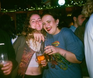 Two girls drinking at a pub before coronavirus