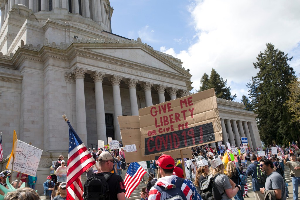 Hundreds gather to protest the state's stay-at-home order, at the Capitol building on April 19, 2020 in Olympia, Washington. Washington state Gov. Jay Inslee instituted the order last month in an effort to slow the spread of the coronavirus (COVID-19). (P