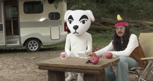 Two human beings cosplaying as KK Slider and Harv from Animal Crossing posing at a picnic table.