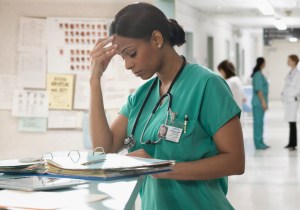 tired nurse doing paperwork