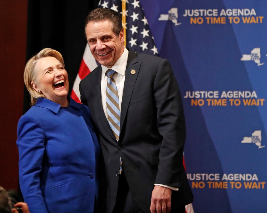 Former Secretary of State Hillary Clinton, left, reacts as she stands on stage with New York Governor Andrew Cuomo, Monday, Jan. 7, 2019, in New York, during a dual appearance at Barnard College where the pair called for codifying abortion rights into New