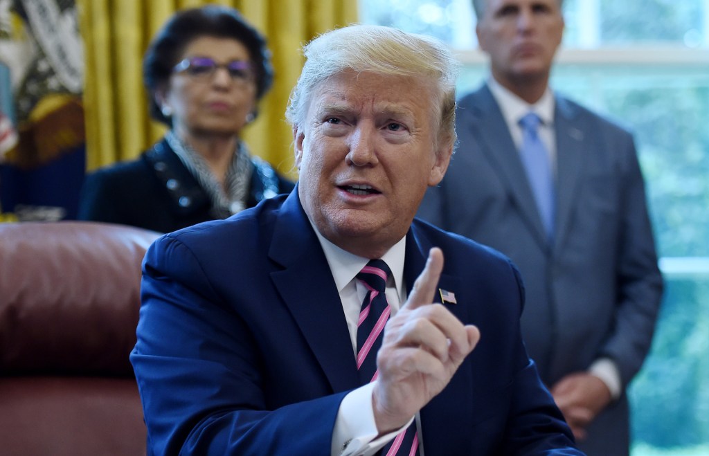 President Donald Trump gestures as he speaks before signing the Paycheck Protection Program and Health Care Enhancement Act in the Oval Office of the White House in Washington, DC, on April 24, 2020.