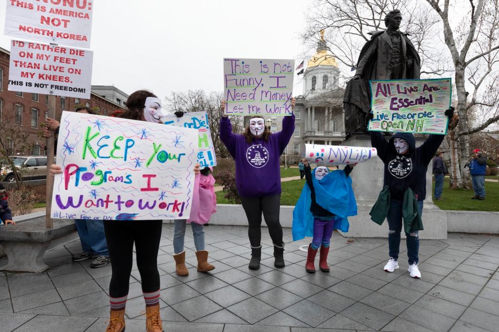 People attend a demonstration against the government mandated lockdown due to concern about COVID-19 at the State House, Saturday, April 18, 2020, in Concord, N.H. (AP Photo/Michael Dwyer)