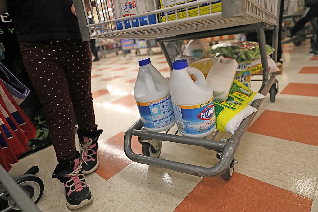 People in the long lines at Market Basket in Waltham, MA buy bleach and frozen peas, among other items, as they prepare for possible quarantine due to coronavirus on March 13, 2020.