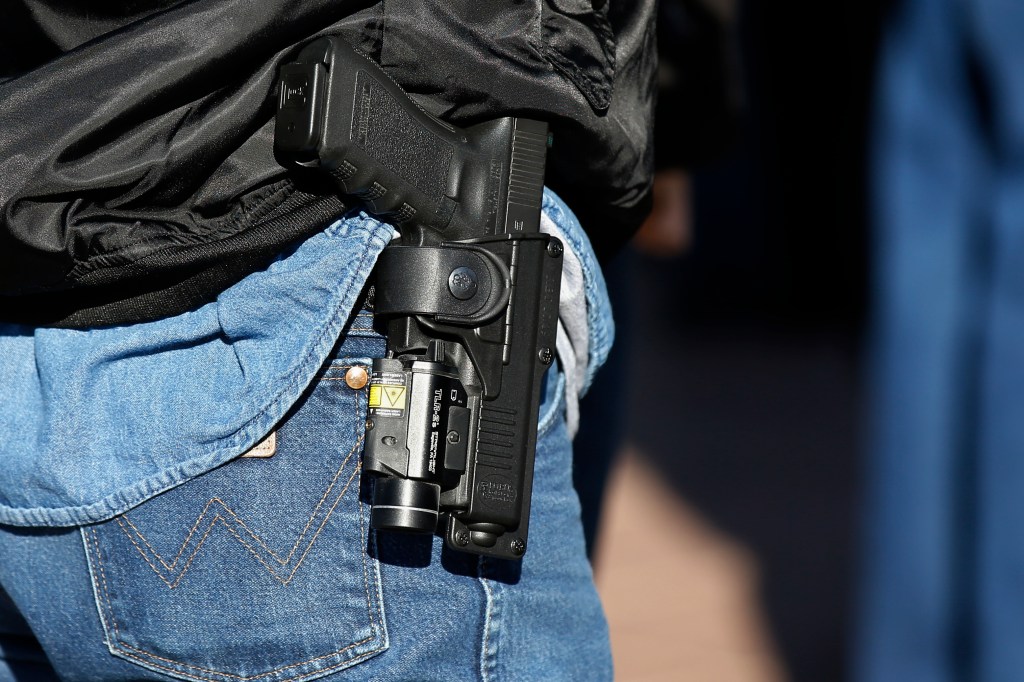 Gun advocates attend a rally at the state Capitol to mark the start of a new law that allows most adults in Oklahoma to carry a firearm in public without a background check or training, Friday, Nov. 1, 2019, in Oklahoma City. (AP Photo/Sue Ogrocki)​