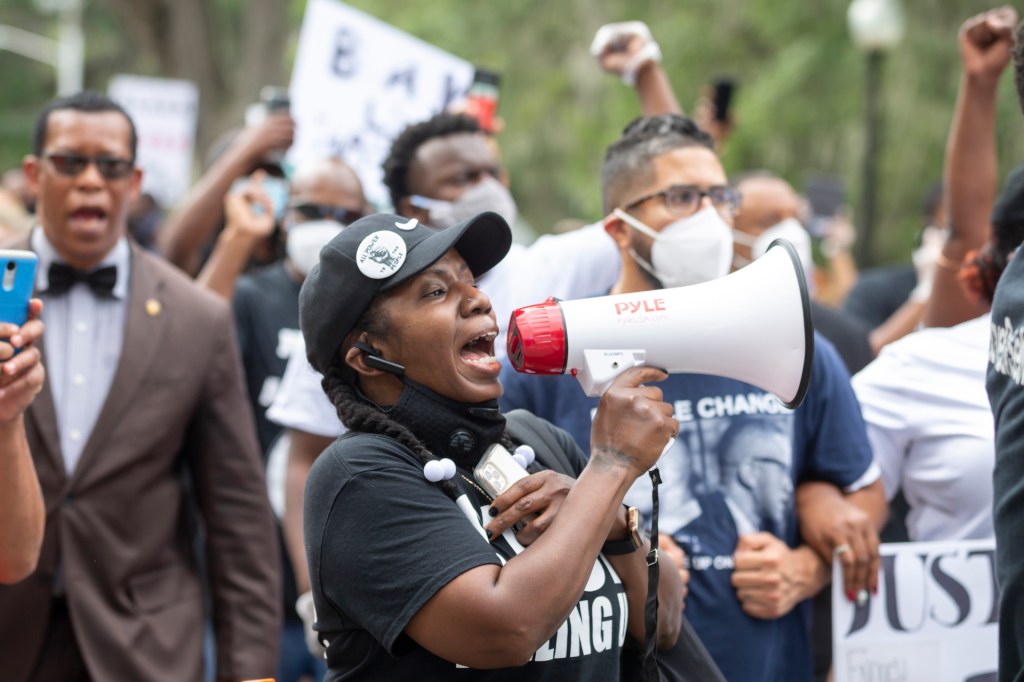 A group of protesters march from the Glynn County Courthouse in downtown to a police station after a rally to protest the shooting of Ahmaud Arbery, Saturday, May 16, 2020, in Brunswick, Ga.