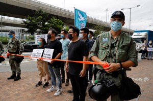 Police officers stop members of the Democratic Party moving forward during a protest near the Chinese central government's liaison office in Hong Kong, Friday, May 22, 2020.