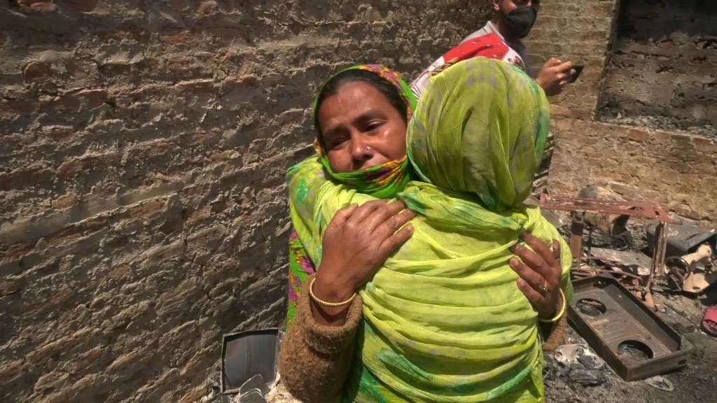 Beba Bashir hugs a friend amidst the rubble of her home in Srinagar, Kashmir's capital city.​