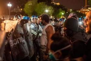 Protesters face off with police outside the White House in Washington, DC, early on May 30, 2020 during a demonstration over the death of George Floyd, a black man who died after a white policeman knelt on his neck for several minutes.