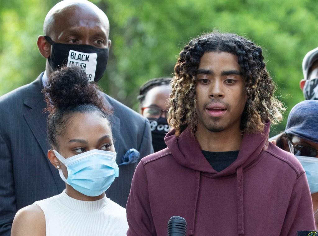 Taniyah Pilgrim holds Messiah Young's bandaged hand as he speaks during a news conference on the campus of Morehouse College Monday, June 1, 2020, in Atlanta.