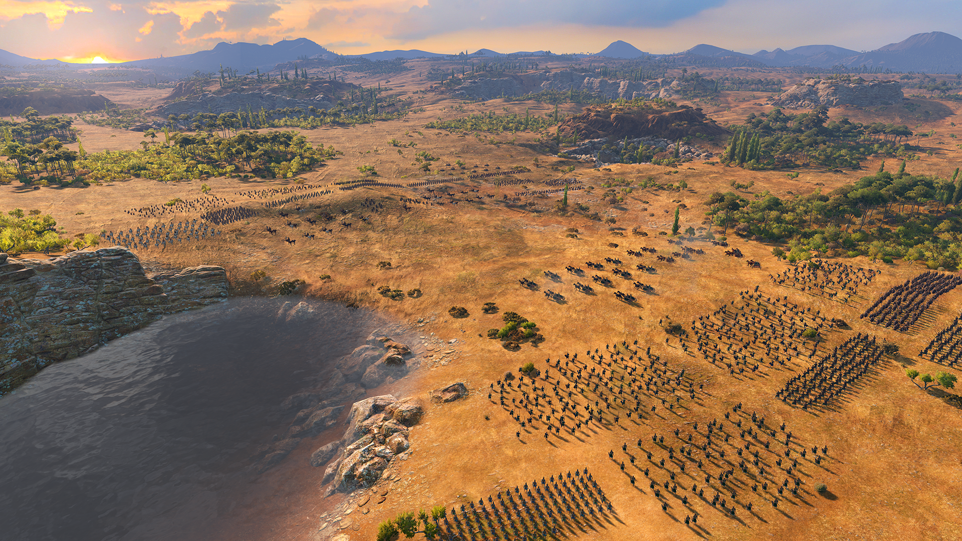 Ranks for Greek and Trojan troops advance through broken, dusty khaki terrain.