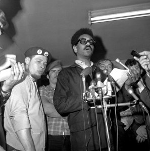 In this June 4, 1969, file photo, Bobby Rush, deputy defense minister of the Illinois Black Panther party, center, reads a statement at a news conference after an early morning raid on Chicago Panther headquarters by FBI agents.