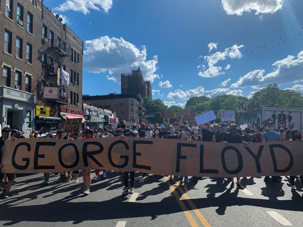 A protester marches through Brooklyn, New York after the killling of George Floyd.