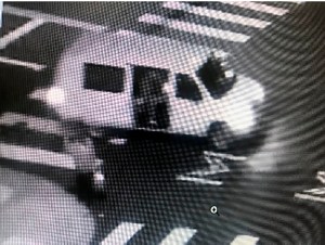 This May 29, 2020 surveillance photo provided by the FBI shows a van with the passenger side door open as someone fires at a security kiosk at the Ronald V. Dellums Federal Building in Oakland, Calif.