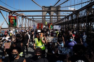 Thousands of protesters march across the Brooklyn Bridge on Juneteenth.