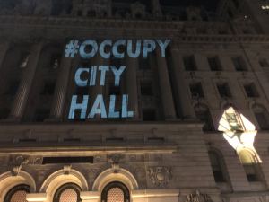 Light projections display messages against police violence on buildings around New York's city hall