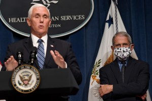 Dr. Anthony Fauci, right, director of the National Institute of Allergy and Infectious Diseases, listens as Vice President Mike Pence speaks during a news conference with the Coronavirus task force at the Department of Health and Human Services in Washing