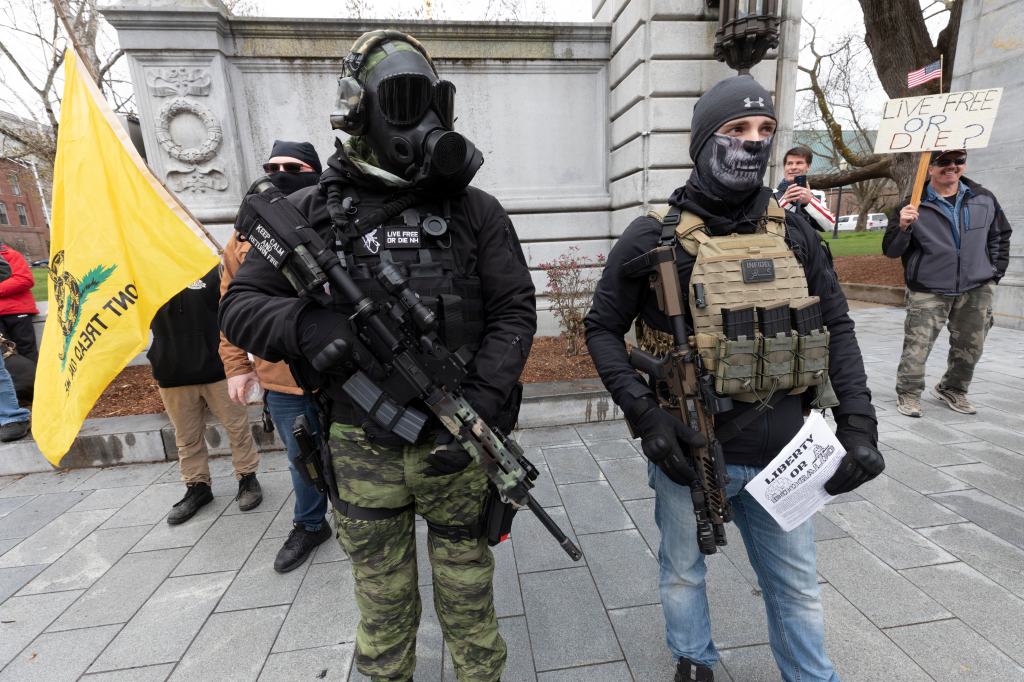 Members of the boogaloo movement attend a demonstration against the lockdown over concern about COVID-19 at the Statehouse, Saturday, April 18, 2020, in Concord, N.H.