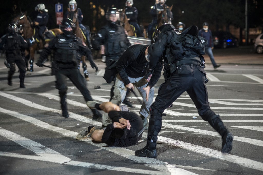 police beat protester serbia