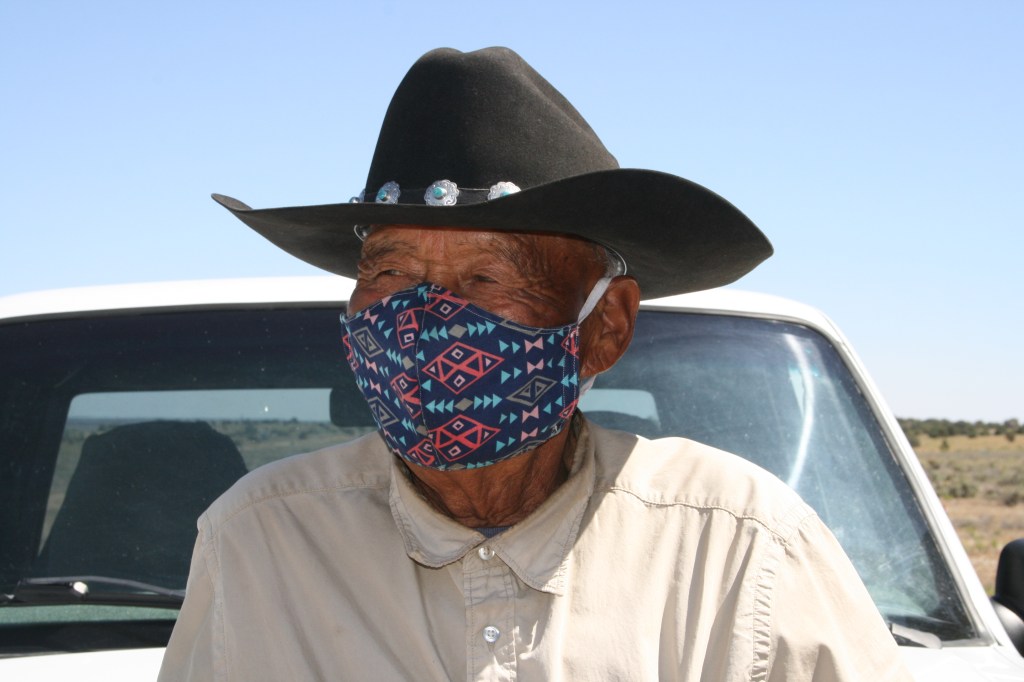 Kee Haskan, 89, stands outside his home in Dilkon, Navajo Nation, on June 17, 2020. Haskan has lived on the reservation his entire life without running water or electricity. He was supposed to have plumbing put in this past spring but construction had to