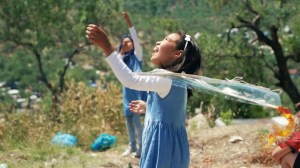 Migrant children play with kites inside the Moria refugee camp.