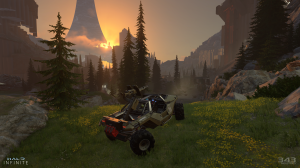 Screenshot from Halo Infinite, a warthog vehicle reaches the top of a hill on a Halo ring world, with the sun setting on the horizon behind a forest.