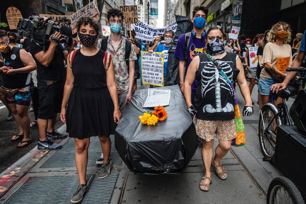 Protesters carry a makeshift coffin representing potential death students and educators face, while a coalition of activists, educators, parents, and students protest to stop the in-person reopening of New York City public schools amidst the COVID-19 pand