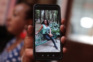 Trans woman Leticia shows a photograph of Camila Díaz who died on Feb. 3, 2020.