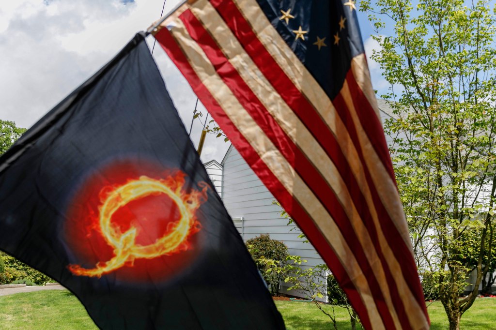 At least one QAnon conspiracy-theorist was among those who protested Oregon's economic-closure efforts aimed at minimizing the lethal impact of coronavirus/Covid-19, at the Governor's Mansion, Mahonia Hall, in Salem, Oregon on April 25, 2020.