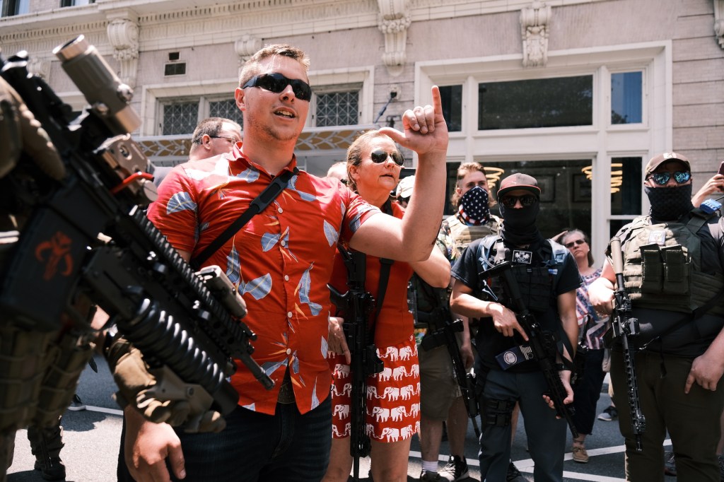 Mike Dunn stands with Virginian senator Amanda Chase during an open carry protest on July 4, 2020 in Richmond, Virginia. (Photo by Eze Amos/Getty Images)