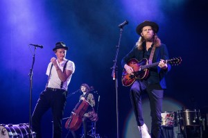 Jeremiah Fraites, from left, Neyla Pekarek and Wesley Schultz of The Lumineers perform at the 2017 KROQ Almost Acoustic Christmas at The Forum on Sunday, Dec. 10, 2017, in Inglewood, Calif. (Photo by Amy Harris/Invision/AP)