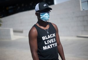 A man wearing a face mask and a t-shirt in support of Black Lives Matter movement during the demonstration. (Photo by Jesus Merida / SOPA Images/Sipa USA)(Sipa via AP Images)