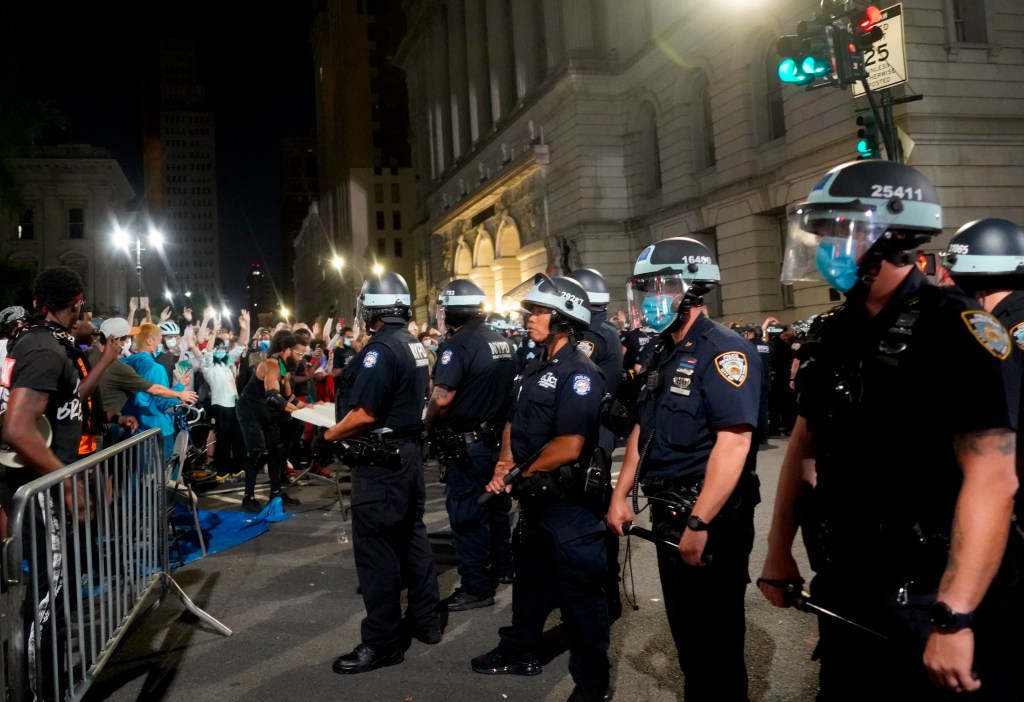 Protesters and police officers clash for the second morning in a row on July 1, 2020 in New York City, US.  (Photo by Selcuk Acar/NurPhoto via AP)