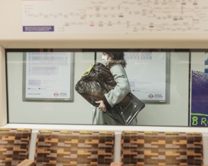 Woman in mask using London underground