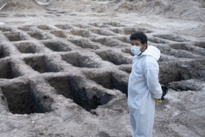 A funeral worker waits to bury a Covid-19 victim in the La Bermeja cemetery in San Salvador, the capital of El Salvador.