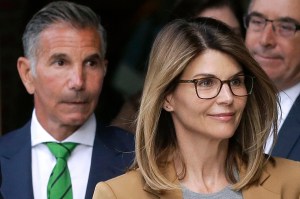 In this April 3, 2019 file photo, actress Lori Loughlin, front, and husband, clothing designer Mossimo Giannulli, left, depart federal court in Boston after facing charges in a nationwide college admissions bribery scandal.