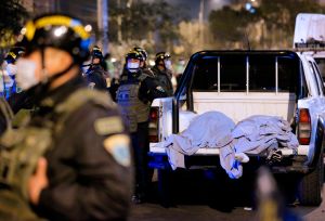 The bodies of some of the victims that suffocated in a crush during a raid on a nightclub in Lima late on August 22, are seen early on August 23, 2020 on the back of a pick-up truck outside the place where a party was being held despite a ban on such gath