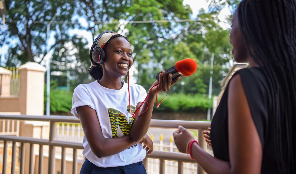 Goodluck Mutoni interviewing a young woman