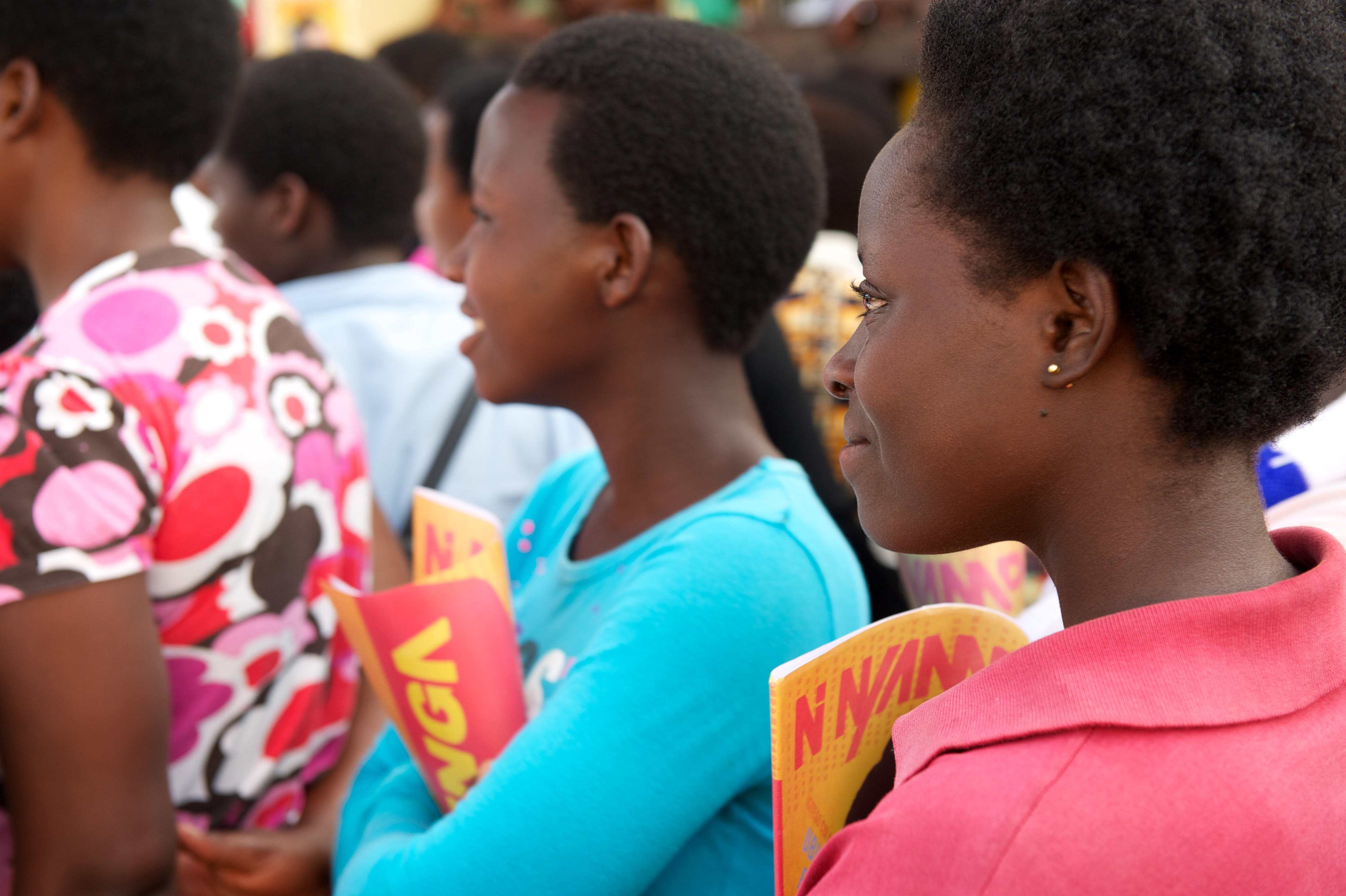 Girls holding Ni Nyampinga magazines at an event.