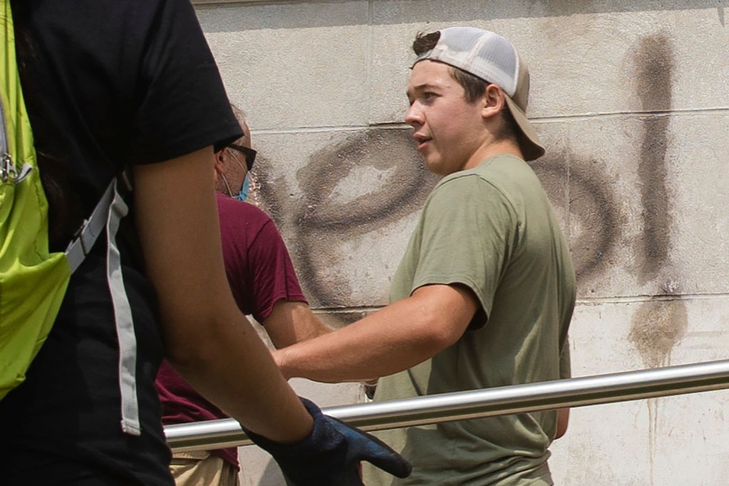 Kyle Rittenhouse, 17, helps clean the exterior of Reuther Central High School in Kenosha, Wis., on Tuesday, Aug. 25, 2020.