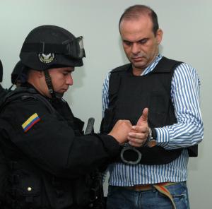 Cover:  Salvatore Mancuso, one of the leaders of the demobilized paramilitary group United Self-Defenses of Colombia (AUC, extreme right) is uncuffed prior to confessing publicly and before a public prosecutor his crimes against the human rights 19 Decemb