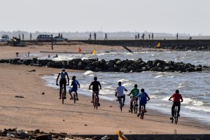 Boys ride their bikes on the beach in Georgetown, Guyana, on March 1, 2020.